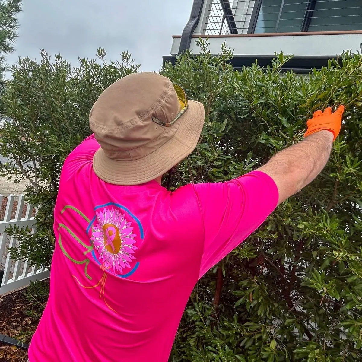 AC Plant & Turf technician trimming a shrub hedge at a home in Lewes, DE