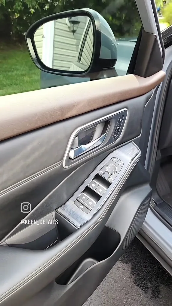 Detailed leather door panel and window controls after an interior detail by Eagle Eye Auto Detailing