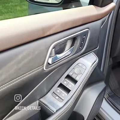 Detailed leather door panel and window controls after an interior detail by Eagle Eye Auto Detailing