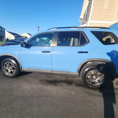 Light blue SUV with a freshly detailed exterior parked in a Delmar, DE driveway by Eagle Eye Auto Detailing