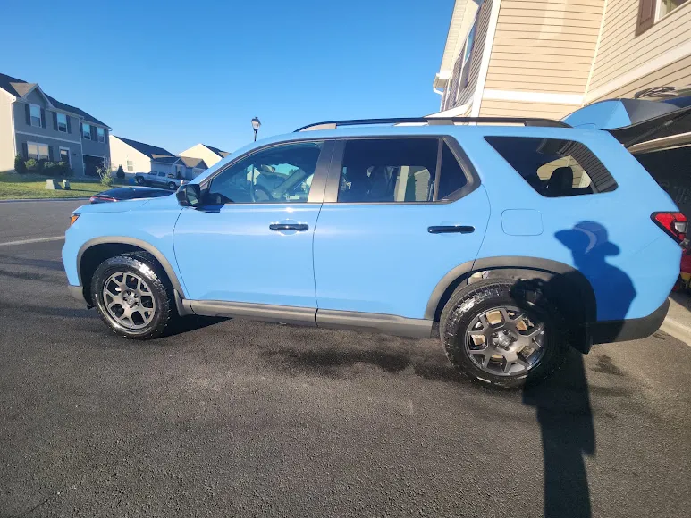 Light blue SUV with a freshly detailed exterior parked in a Delmar, DE driveway by Eagle Eye Auto Detailing