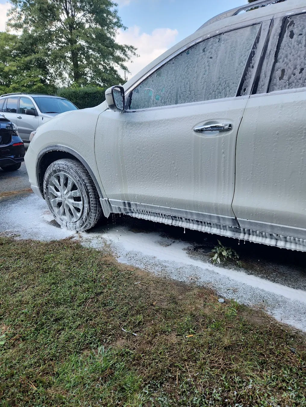 White SUV covered in foam during an exterior wash by Eagle Eye Auto Detailing