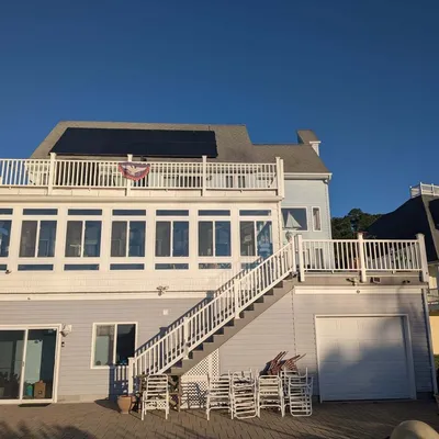 Completed home exterior with solar panels and a new deck by Eastern Shore Roofing and Remodeling in Snow Hill, MD