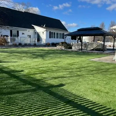 Artificial turf lawn installation in a residential backyard by Elzey Services in Delmar, MD
