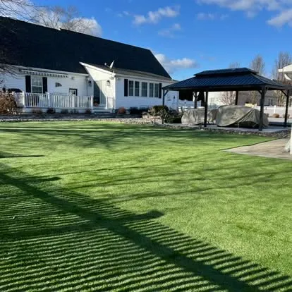 Artificial turf lawn installation in a residential backyard by Elzey Services in Delmar, MD