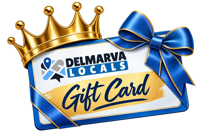 A Delmarva Locals gift card wrapped in a blue ribbon and topped with a gold crown
