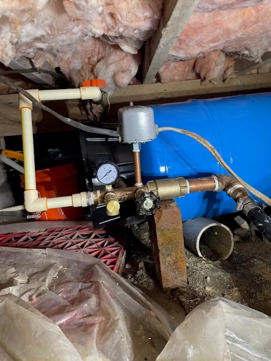 Well pressure tank and pump system installed in a crawlspace by Legar & Son Plumbing in Salisbury, MD