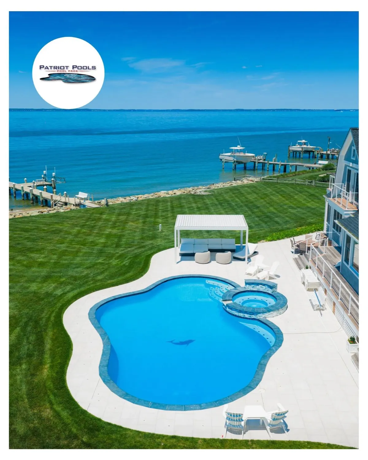 Freeform waterfront pool and hot tub installed by Patriot Pools overlooking the water near Centreville, MD