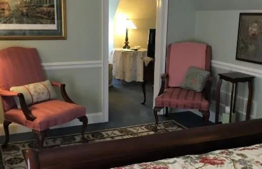 Upstairs sitting area with upholstered armchairs at The Parsonage Inn in St. Michaels, MD