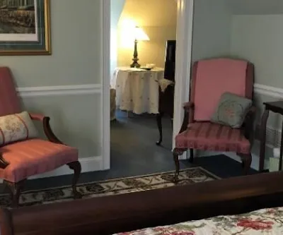 Upstairs sitting area with upholstered armchairs at The Parsonage Inn in St. Michaels, MD